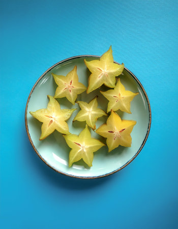 Averrhoa carambola, starfruit fruit, isolated on a pastel blueの写真素材