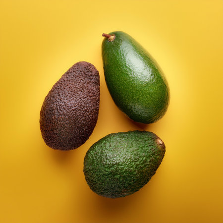 Avocado fruit, isolated on a pastel yellowの写真素材