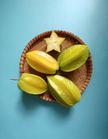 Averrhoa carambola, starfruit fruit, isolated on a pastel blueの写真素材