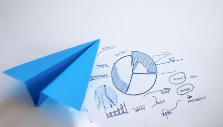 Blue paper plane and business strategy on white backgroundの写真素材