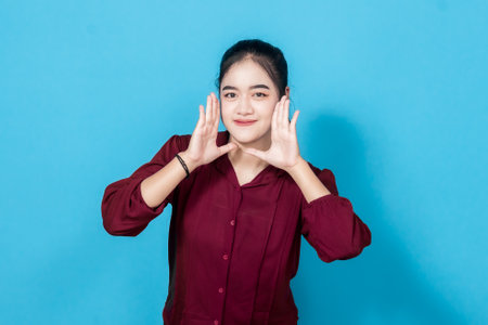 A young woman gestures while expressing an alert or calling out concept against a blue background.