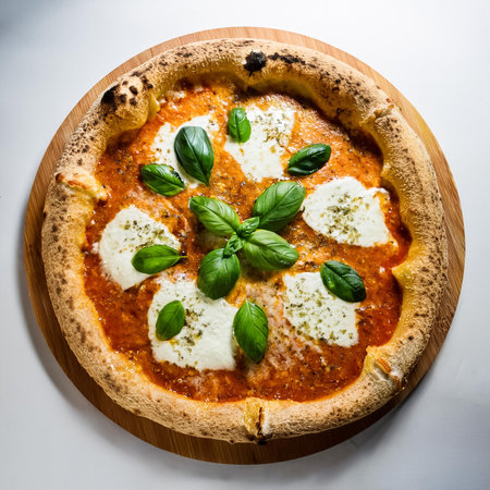 neapolitan homemade pizza margarita from the brick oven. Italian Pizza with fresh mozzarella and basil leaves, isolated on a clean white backgroundの写真素材
