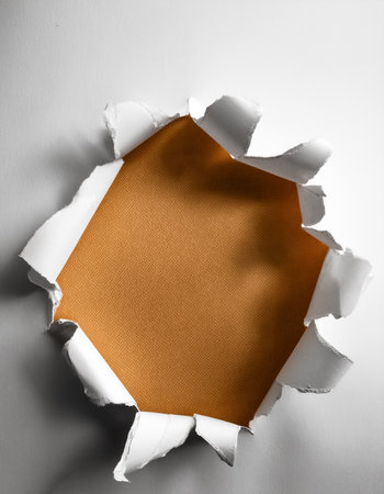 Ragged hole torn in ripped paperの写真素材