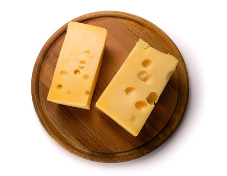Two pieces of cheese on a wooden board against a white backgroundの写真素材