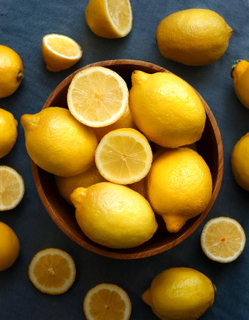 fresh lemons. Creative background design with food theme, focus on the pile of fresh lemonsの写真素材