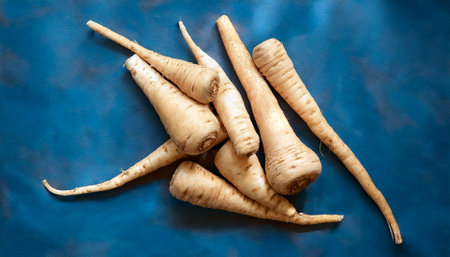 Root vegetables such as parsnips, focus on the pile of fresh Root vegetables such as parsnips
