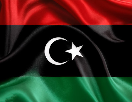 Libya Flag waving in the wind. Close up of Libya banner blowing, soft and smooth silk. Cloth fabric texture ensign backgroundの写真素材