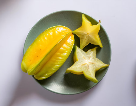 starfruit, isolated against a clean, smooth white backgroundの写真素材