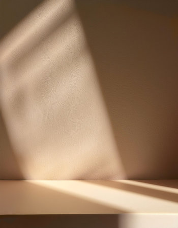 Empty biege background for product presentation with beautiful lights and shadowsの写真素材