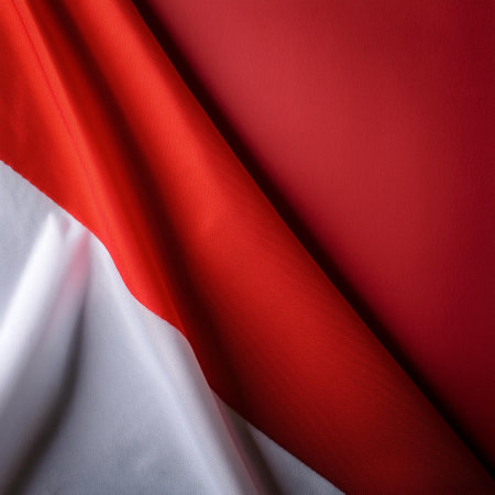 Indonesian flag waving in the wind on side position provides copy space for text isolated dark red backgroundの写真素材