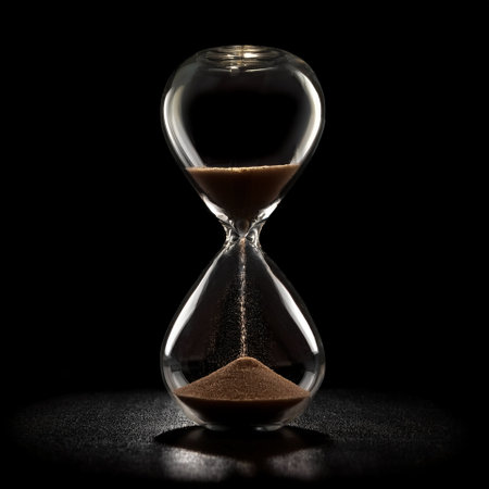 Hourglass sandglass, isolated on a dark blackの写真素材