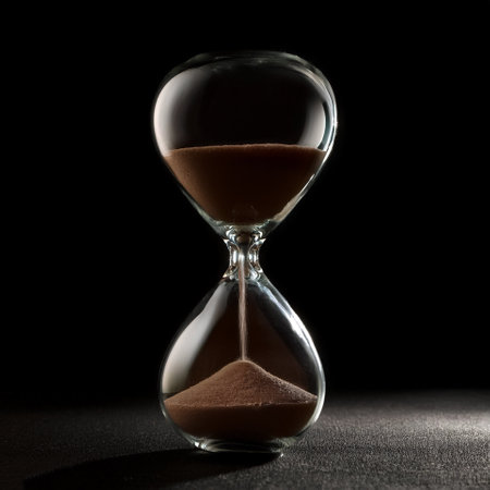 Hourglass sandglass, isolated on a dark black