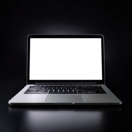 Laptop with white screen, isolated on a dark blackの写真素材
