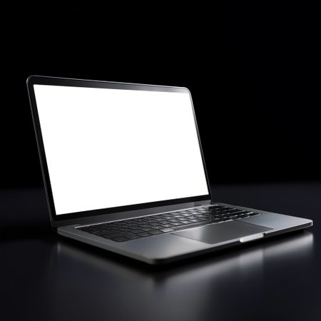Laptop with white screen, isolated on a dark blackの写真素材