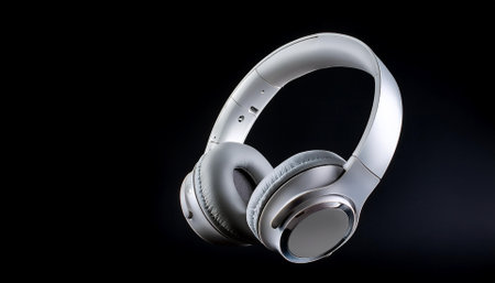 White metallic wireless headphones isolated on a dark blackの写真素材