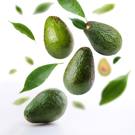 Fresh Avocado fruits with leaves floating or flying isolated white background