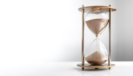A classic hourglass filled with sand marking the passage of time on side position provides copy space for text. background concept isolated whiteの写真素材