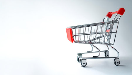 Empty shopping cart with red handle on side position provides copy space for text. background...