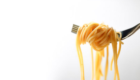 Spaghetti on a fork on side position provides copy space for text. background concept isolated whiteの写真素材
