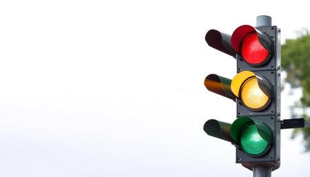 Traffic light on side position provides copy space for text. background concept isolated white