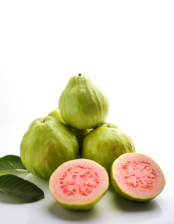 guava fruit whole and sliced scattered around background concept isolated white