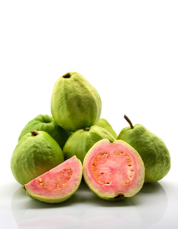 guava fruit whole and sliced scattered around background concept isolated white