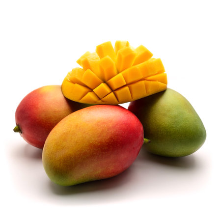 mangoes whole and sliced scattered around background concept isolated whiteの写真素材