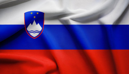 Republic of Slovenia flag waving in the wind. Close up of Republic of Slovenia flag banner blowing, soft and smooth silk. Cloth fabric texture ensign background. Use it for national day and country occasions conceptの写真素材