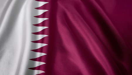 State of Qatar flag waving in the wind. Close up of State of Qatar flag banner blowing, soft and smooth silk. Cloth fabric texture ensign background. Use it for national day and country occasions conceptの写真素材