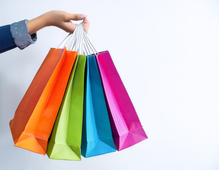 Female hand holding many colorful shopping bags, template. Mockupの写真素材