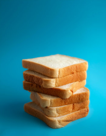 Delicious bread slices on side position provides copy space for text. background concept isolated light blue backgroundの写真素材
