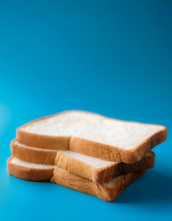 Delicious bread slices on side position provides copy space for text. background concept isolated light blue backgroundの写真素材