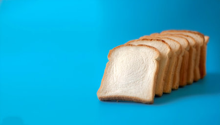 Delicious bread slices on side position provides copy space for text. background concept isolated light blue backgroundの写真素材