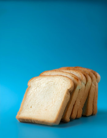 Delicious bread slices on side position provides copy space for text. background concept isolated light blue backgroundの写真素材