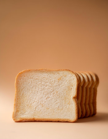 Delicious bread slices on side position provides copy space for text. background concept isolated biege backgroundの写真素材