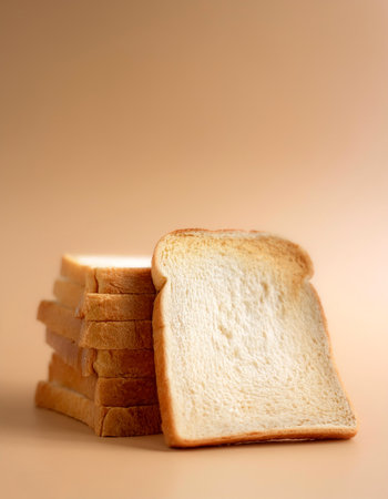 Delicious bread slices on side position provides copy space for text. background concept isolated biege backgroundの写真素材