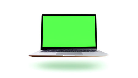 Laptop with green screen floating or flying isolated white backgroundの写真素材