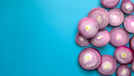 red onion slices. pattern texture on side position provides copy space for text. background concept isolated light blue backgroundの写真素材