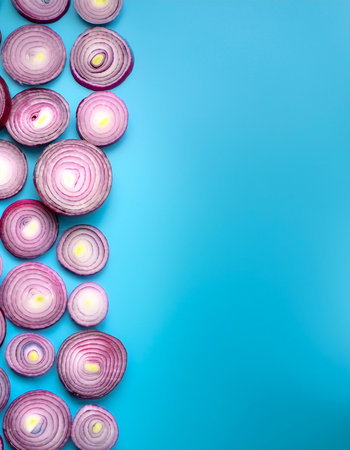 red onion slices. pattern texture on side position provides copy space for text. background concept isolated light blue backgroundの写真素材