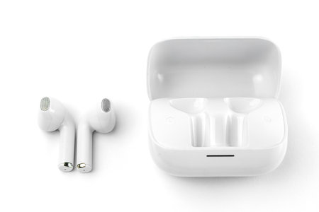 Modern white wireless earbuds with a matching charging case. Ergonomic fit, lightweight, and perfect for music, calls, gaming, and workouts with high-quality sound and noise isolationの写真素材