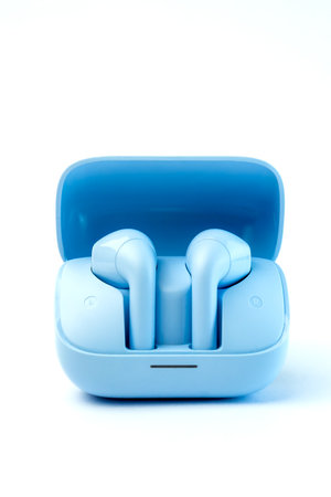 Stylish blue wireless earbuds with a matching charging case, ergonomic design, and superior sound quality. Ideal for music, calls, gaming, and workouts with noise reduction.の写真素材