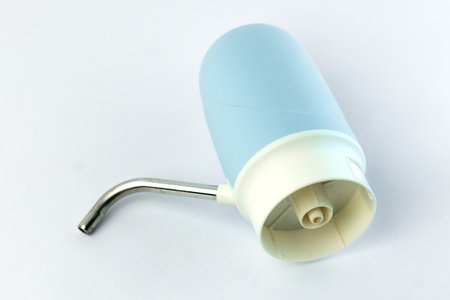 Portable electric water dispenser with a sleek blue and white design. Ideal for easy water dispensing from gallon bottles. Rechargeable, lightweight, and perfect for home or office use.の写真素材