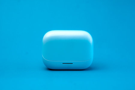 A modern wireless earbuds charging case in a sleek blue design, isolated on a vibrant blue background. Compact, lightweight, and stylish, perfect for travel and daily use.の写真素材