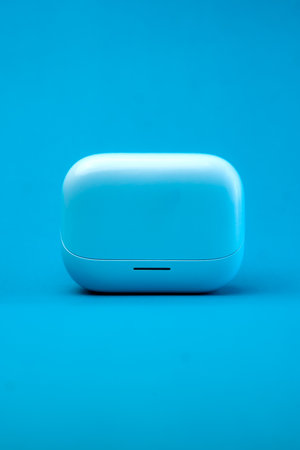 A modern wireless earbuds charging case in a sleek blue design, isolated on a vibrant blue background. Compact, lightweight, and stylish, perfect for travel and daily use.の写真素材