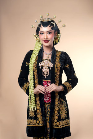 Indonesian woman in traditional Javanese bridal attire, showcasing paes makeup, jasmine garlands, ornate embroidery, and poised elegance for cultural, wedding, or Kartini-themed visuals.の写真素材