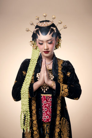 Indonesian woman in traditional Javanese bridal attire, showing paes makeup, jasmine garlands, and a...