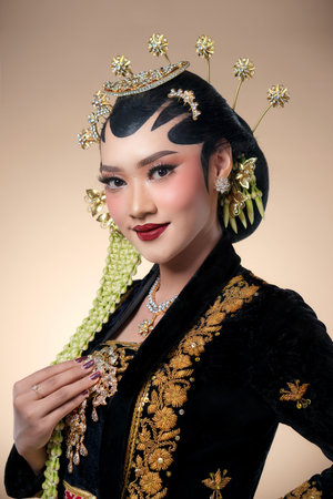 Indonesian woman in elegant Javanese bridal makeup and traditional attire, showcasing refined expression, ornate accessories, and graceful cultural charm.の写真素材