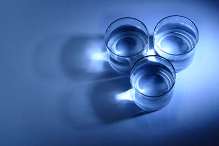 Three glasses of water in a dark blue backgroundの写真素材