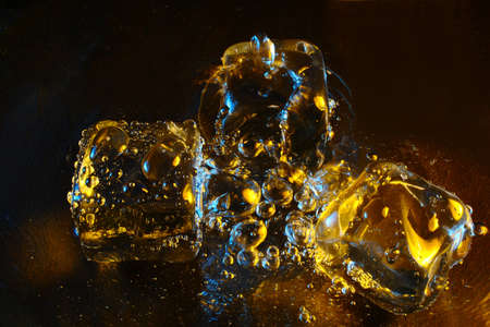 Ice cube with bubbles catching ambient lightsの写真素材