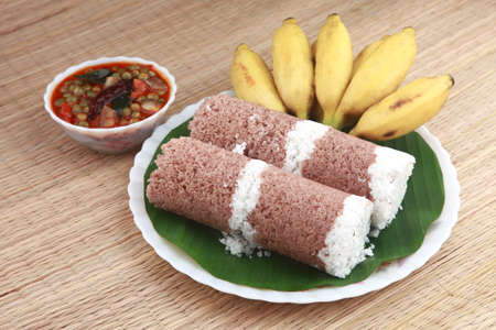 Indian breakfast Puttu with curry and a bunch of banana.